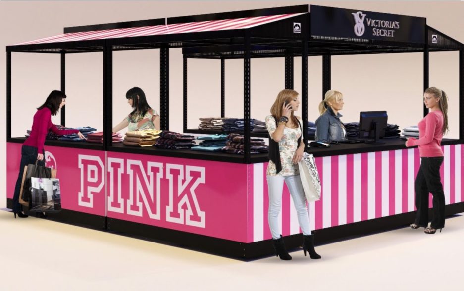 A quad kiosk configuration in a bright pink vinyl wrap for clothing vendors