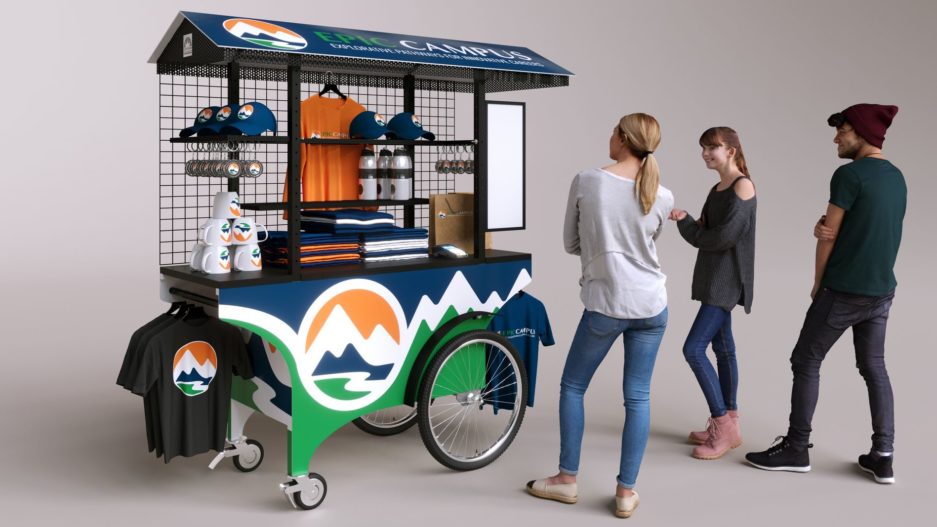 A highly mobile push cart for school apparel merchandising, wrapped in a blue, green and white vinyl wrap