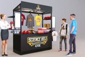 A mobile retail kiosk in a matte black with LED lighting installed, showcasing the retail display capabilities of the unit.