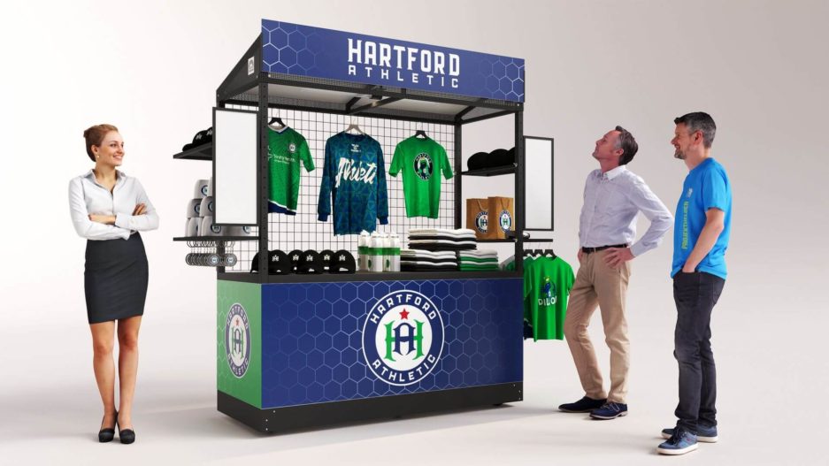 A mobile retail display for a university in a blue and green custom vinyl wrap