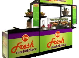 An example of bright and fresh cart graphics in a light green with red and purple branding. Also shown is two matching menu boards and a portable sink