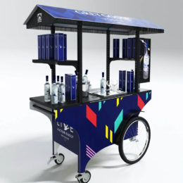 A custom push cart designed for selling Grey Goose vodka, but well suited for the promotion of any alcoholic beverage.