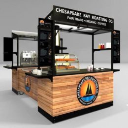 A portable, modular configuration of two cappuccino carts to serve customers on two sides. Wrapped in a beautiful wood panel design with branding on the canopy, base and doors.